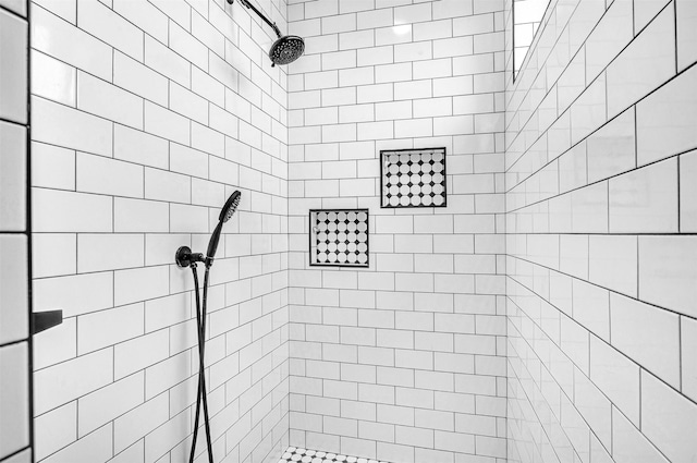 full bath featuring a tile shower