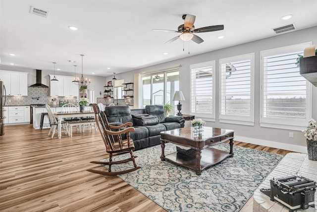 living area featuring light wood-style flooring, visible vents, and recessed lighting