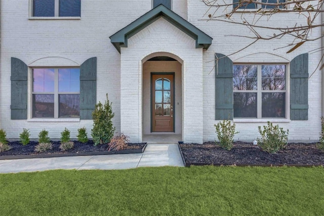 doorway to property with a yard