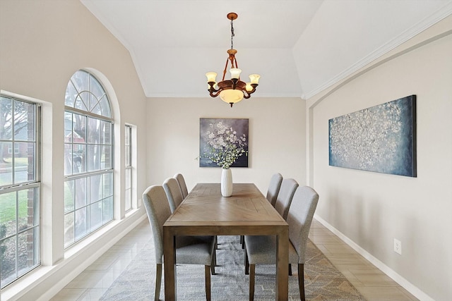 dining area featuring an inviting chandelier, crown molding, and vaulted ceiling