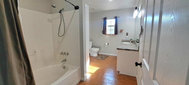 full bathroom with vanity, hardwood / wood-style floors, shower / bathtub combination, and toilet