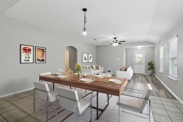 dining room featuring light tile patterned floors, vaulted ceiling, and ceiling fan