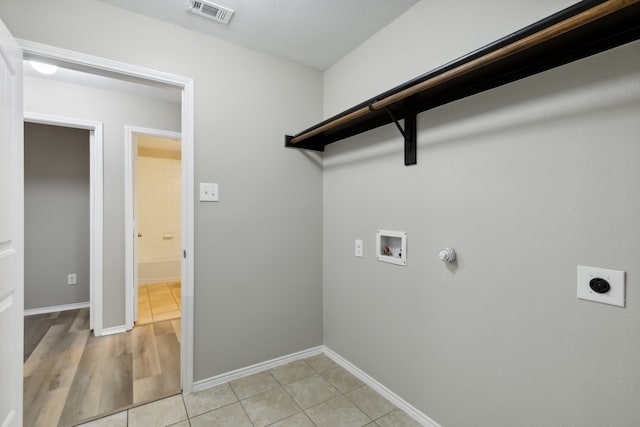 clothes washing area with gas dryer hookup, hookup for an electric dryer, laundry area, washer hookup, and visible vents