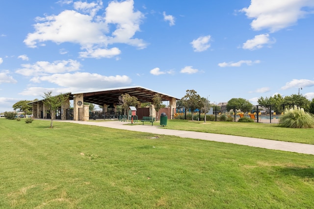 view of home's community featuring fence and a yard