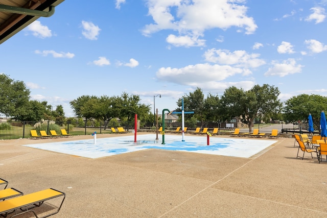 view of sport court featuring playground community and fence