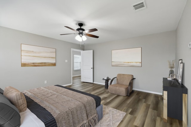 bedroom with a ceiling fan, baseboards, visible vents, and dark wood-type flooring