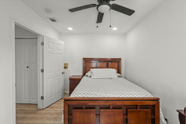 bedroom with ceiling fan, a closet, and light hardwood / wood-style flooring