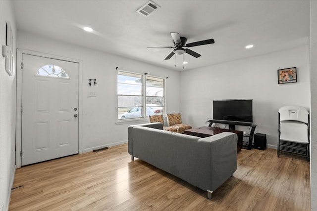 living room with ceiling fan and light wood-type flooring