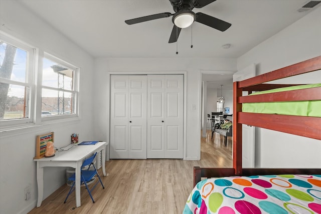 bedroom featuring light hardwood / wood-style floors, a closet, and ceiling fan