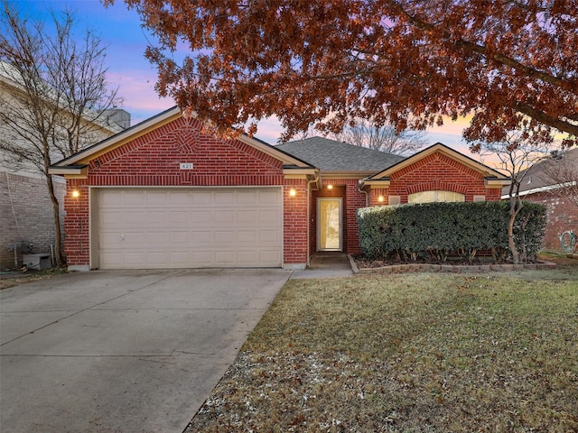 view of front of home featuring a garage and a lawn