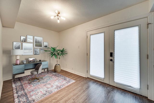 2722 Knight St Unit 316C, Dallas, TX 75219 - office area featuring french doors, wood finished floors, baseboards, and a textured ceiling