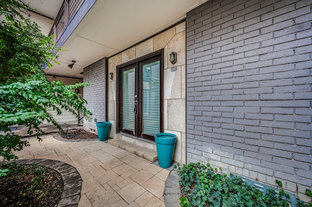 entrance to property featuring a patio and french doors