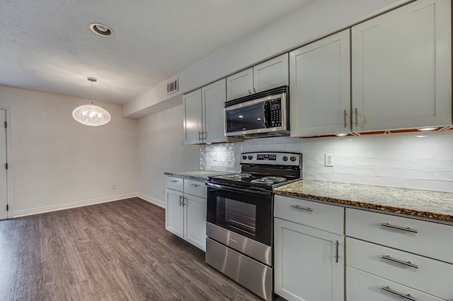 2722 Knight St Unit 316C, Dallas, TX 75219 - kitchen featuring appliances with stainless steel finishes, dark wood-style floors, decorative backsplash, baseboards, and light stone counters