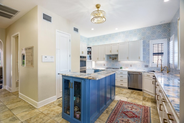 kitchen with sink, stainless steel appliances, white cabinets, and blue cabinets