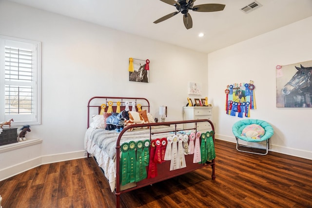 bedroom with dark hardwood / wood-style floors and ceiling fan