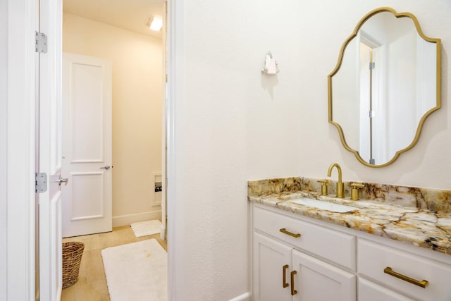 bathroom featuring vanity and wood-type flooring