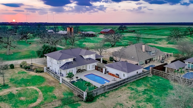 aerial view at dusk featuring a rural view