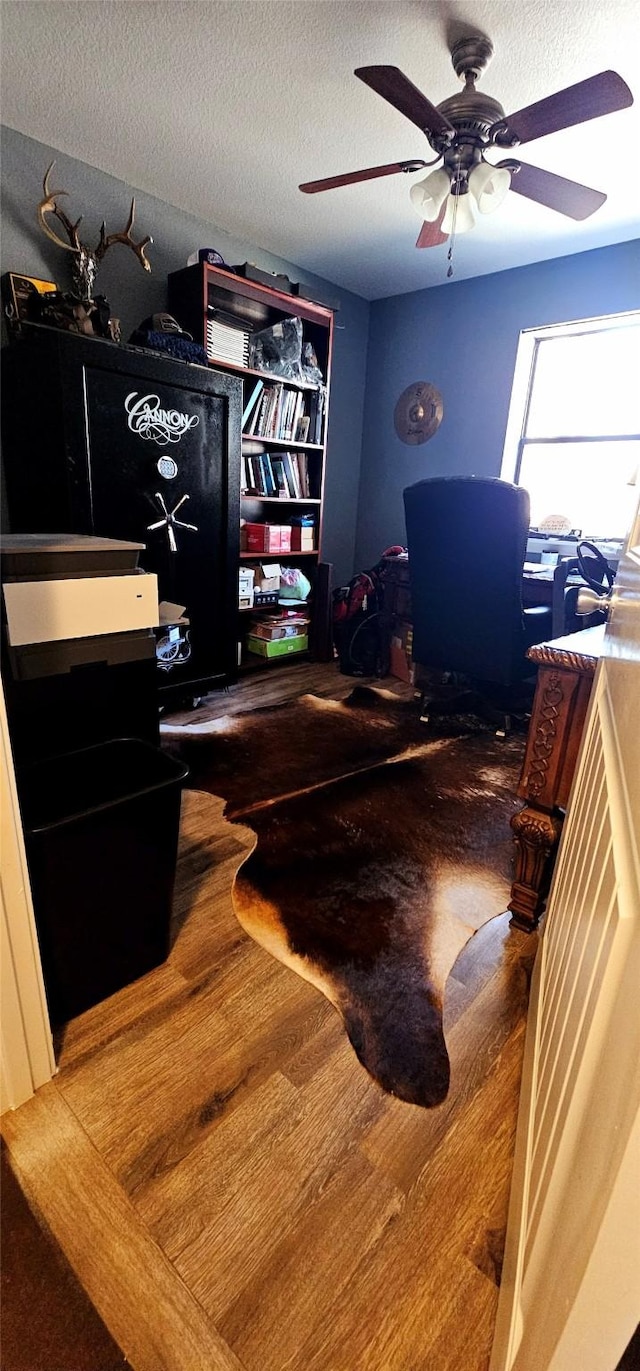 home office with ceiling fan, wood-type flooring, and a textured ceiling