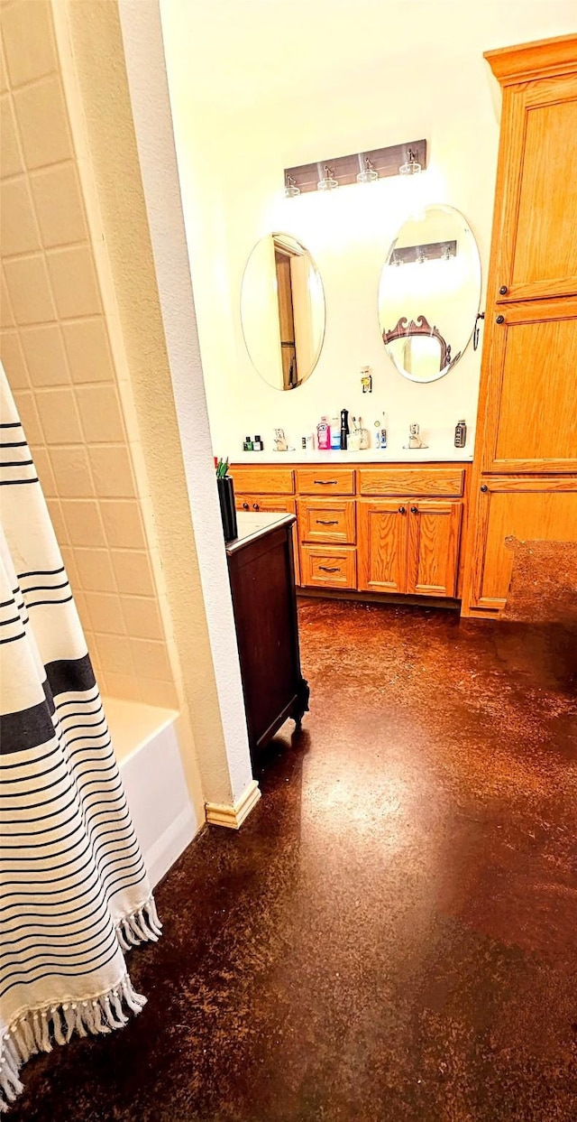 bathroom featuring vanity and shower / bathtub combination with curtain