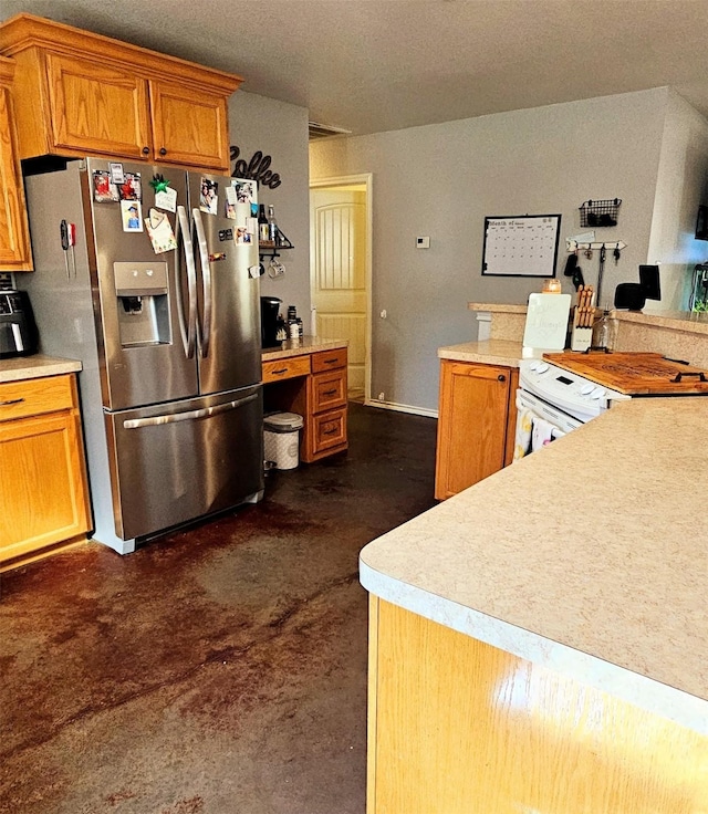 kitchen featuring stainless steel fridge and white range