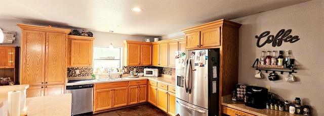 kitchen with stainless steel appliances, tasteful backsplash, and sink