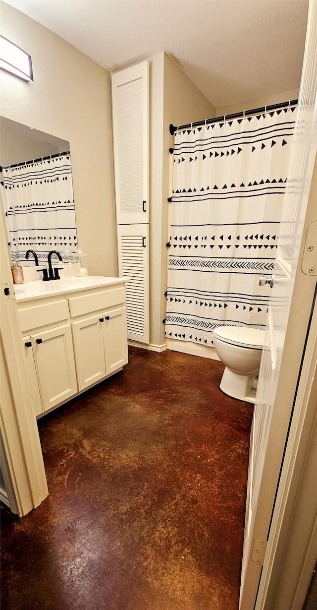 bathroom featuring vanity, walk in shower, concrete floors, and toilet