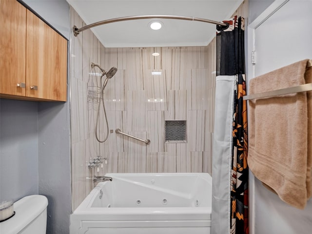 bathroom featuring shower / tub combo and toilet