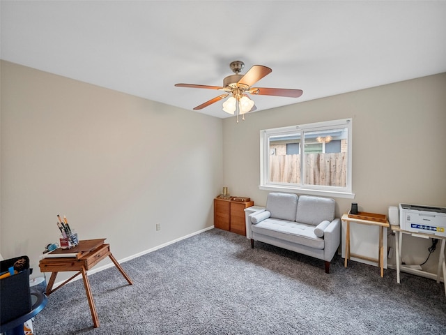 living area featuring dark carpet and ceiling fan