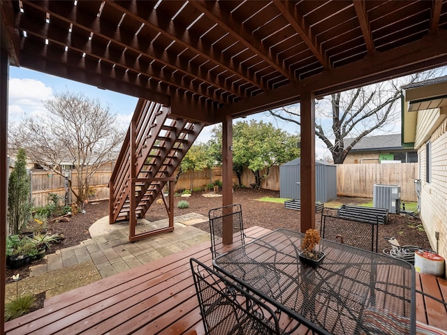 wooden terrace featuring a patio, a shed, and central air condition unit