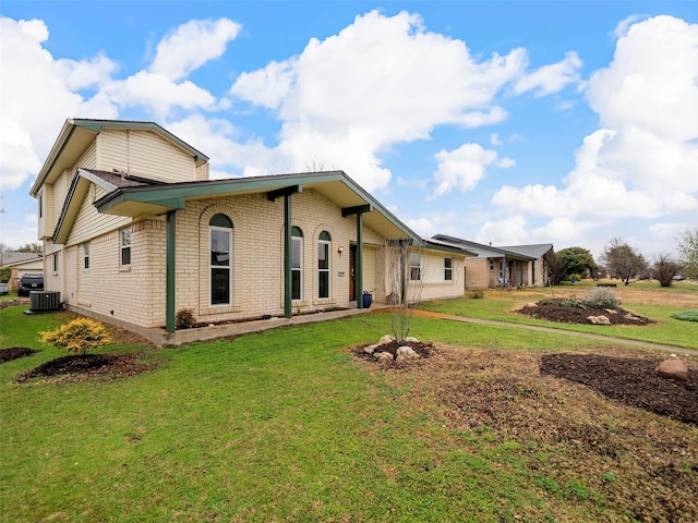 view of front of home with a front yard and central air condition unit