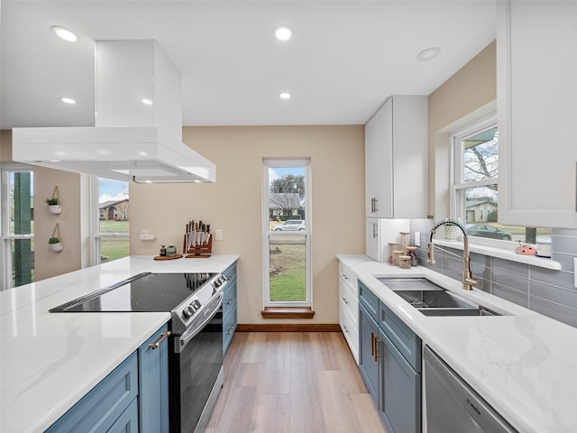 kitchen featuring sink, white cabinetry, stainless steel appliances, light stone countertops, and island exhaust hood