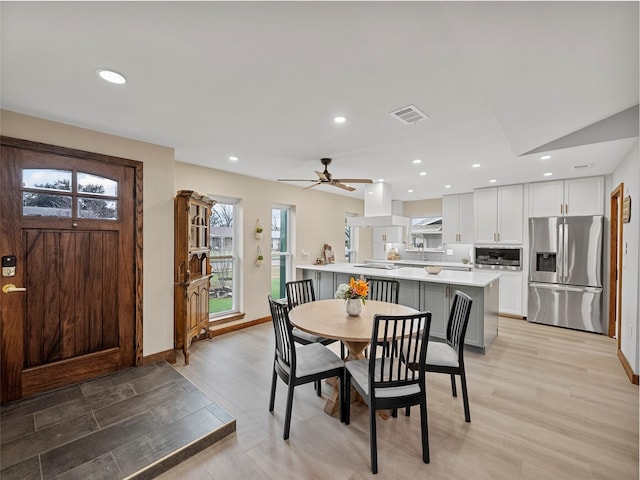 dining area featuring ceiling fan and light hardwood / wood-style floors