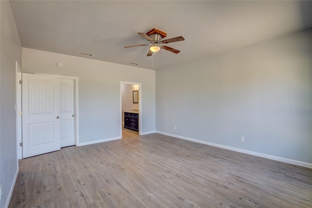 4340 Fm 1563, Wolfe City, TX 75496 - unfurnished bedroom with visible vents, light wood-style flooring, baseboards, ceiling fan, and connected bathroom