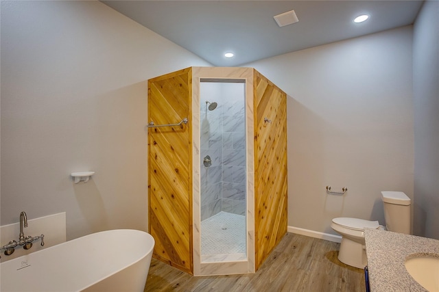 4340 Fm 1563, Wolfe City, TX 75496 - bathroom featuring wood finished floors, toilet, a shower stall, and a freestanding bath