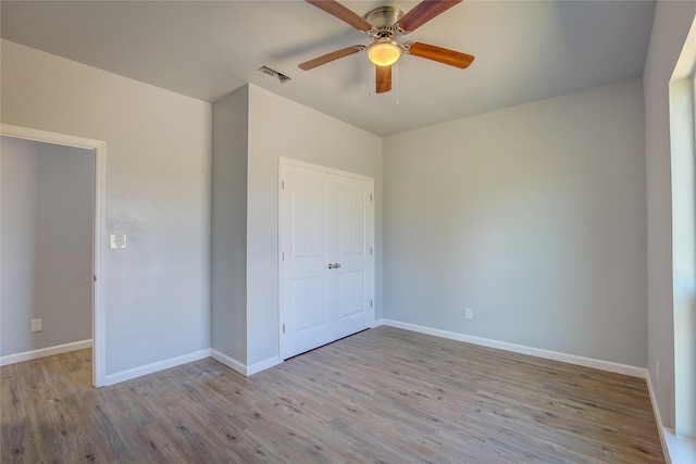 4340 Fm 1563, Wolfe City, TX 75496 - unfurnished bedroom with visible vents, a closet, baseboards, and wood finished floors