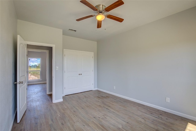 4340 Fm 1563, Wolfe City, TX 75496 - unfurnished bedroom featuring baseboards, light wood-style floors, ceiling fan, visible vents, and a closet