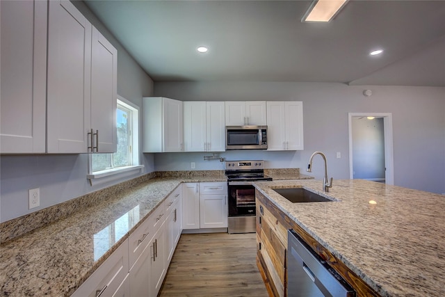 4340 Fm 1563, Wolfe City, TX 75496 - kitchen with white cabinets, a sink, stainless steel appliances, and light wood-style flooring