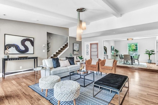 living room featuring light wood-type flooring and beam ceiling