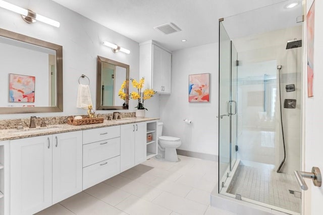 bathroom with vanity, toilet, and a shower with door