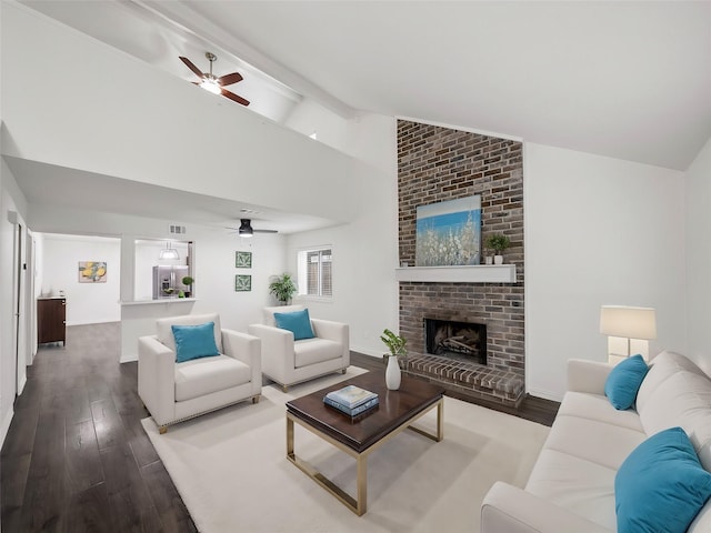 living area with visible vents, a fireplace, baseboards, and wood finished floors