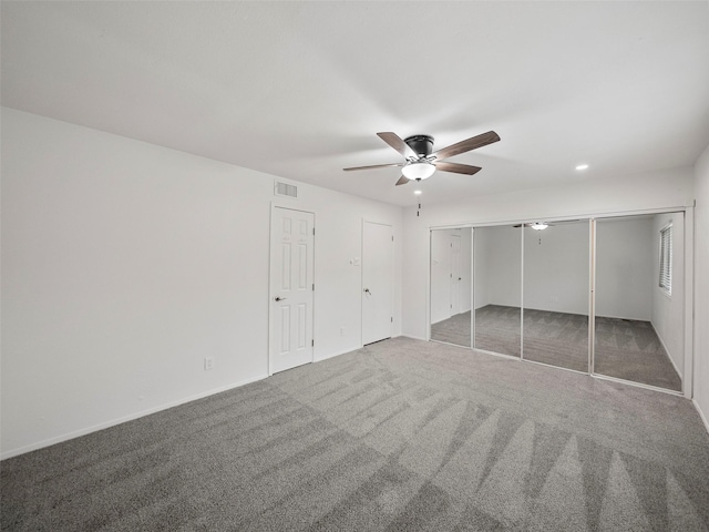 unfurnished bedroom with carpet flooring, visible vents, and a ceiling fan