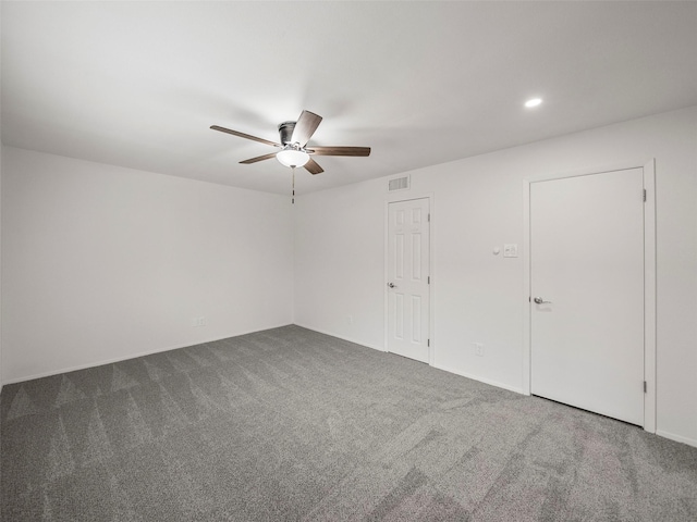 empty room with a ceiling fan, visible vents, carpet flooring, and recessed lighting