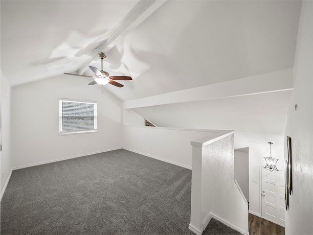 additional living space with lofted ceiling with beams, baseboards, dark carpet, and ceiling fan with notable chandelier