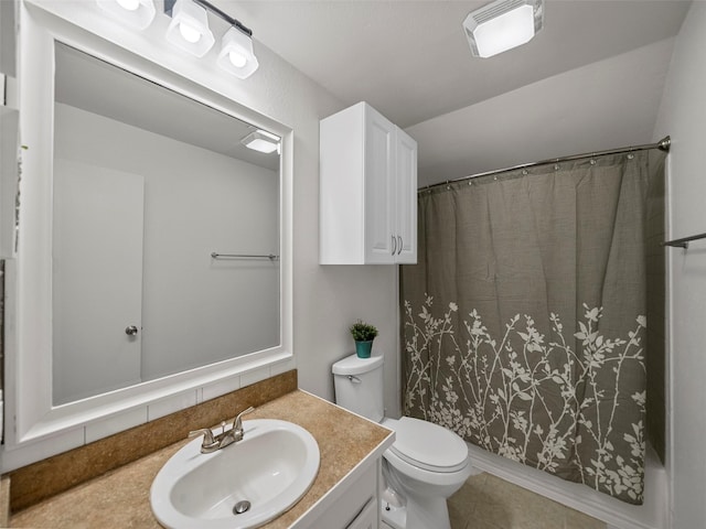 bathroom with visible vents, vanity, toilet, and tile patterned floors