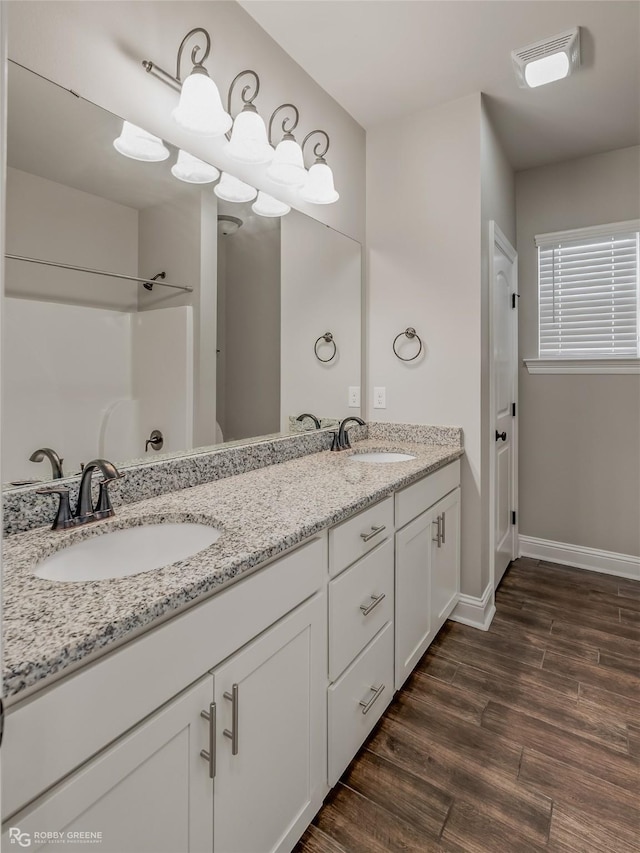 bathroom with vanity and hardwood / wood-style floors