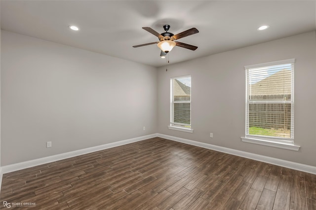 spare room with ceiling fan and dark hardwood / wood-style floors