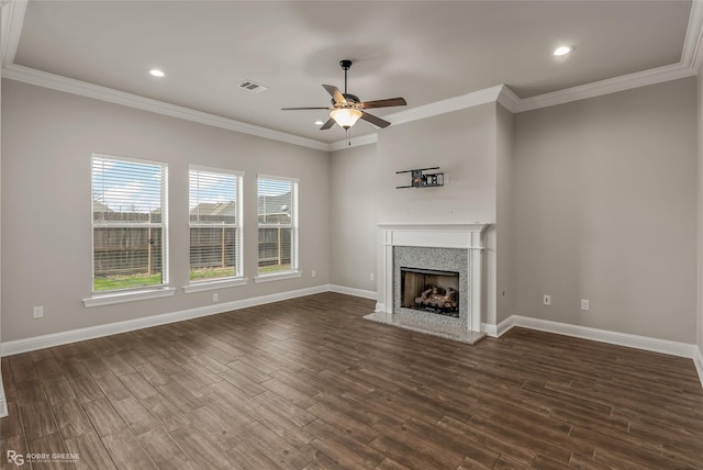 unfurnished living room with dark wood-type flooring, ornamental molding, and ceiling fan