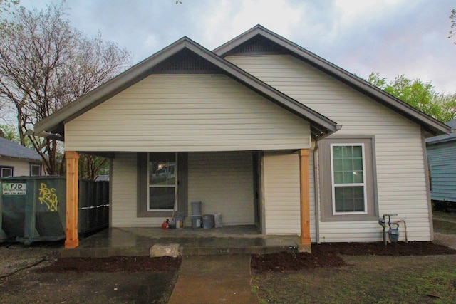 rear view of house featuring a porch