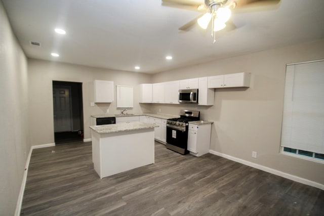 kitchen featuring sink, a center island, white cabinets, and appliances with stainless steel finishes