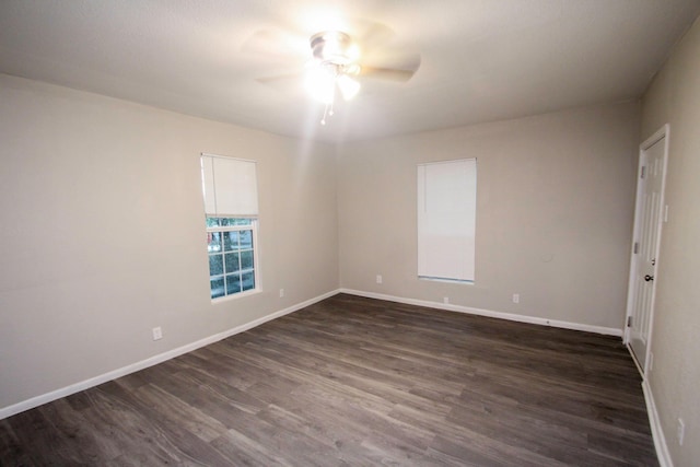 empty room featuring dark wood-type flooring and ceiling fan